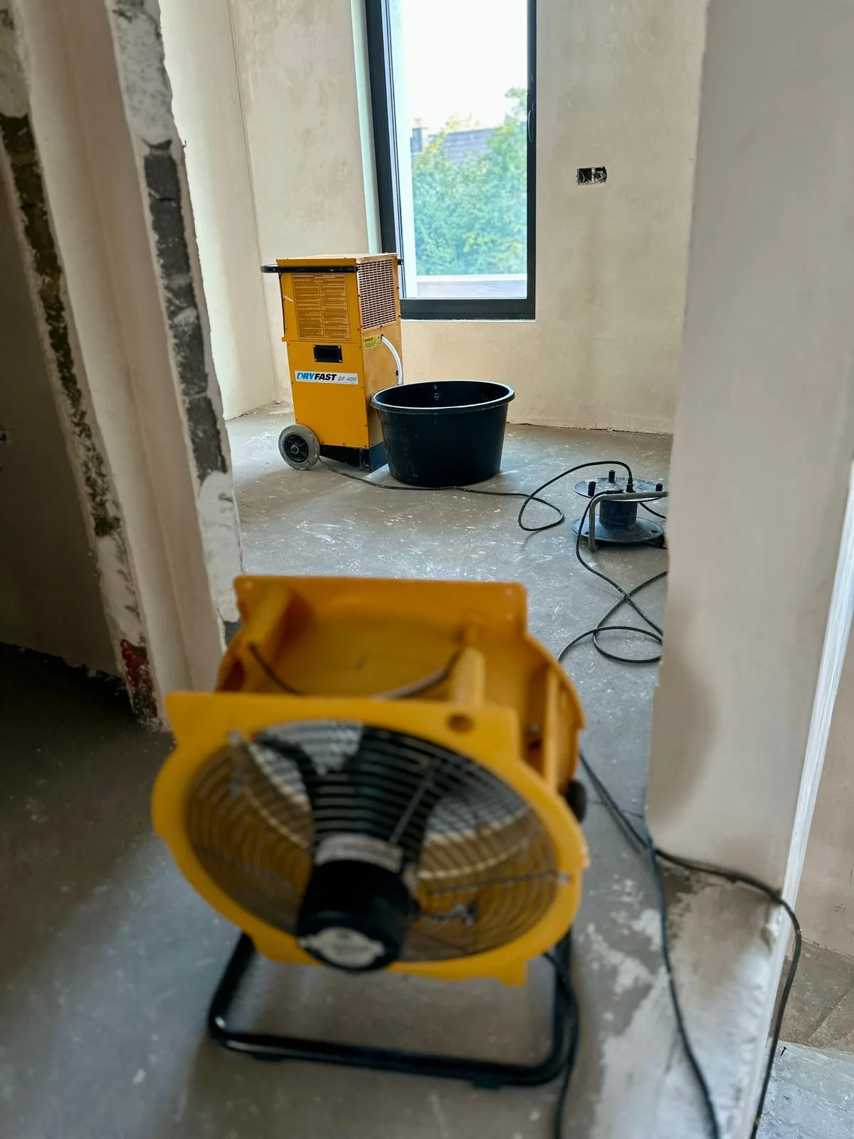 Fan and Dryfast DF400 dehumidifier combined on a renovation site