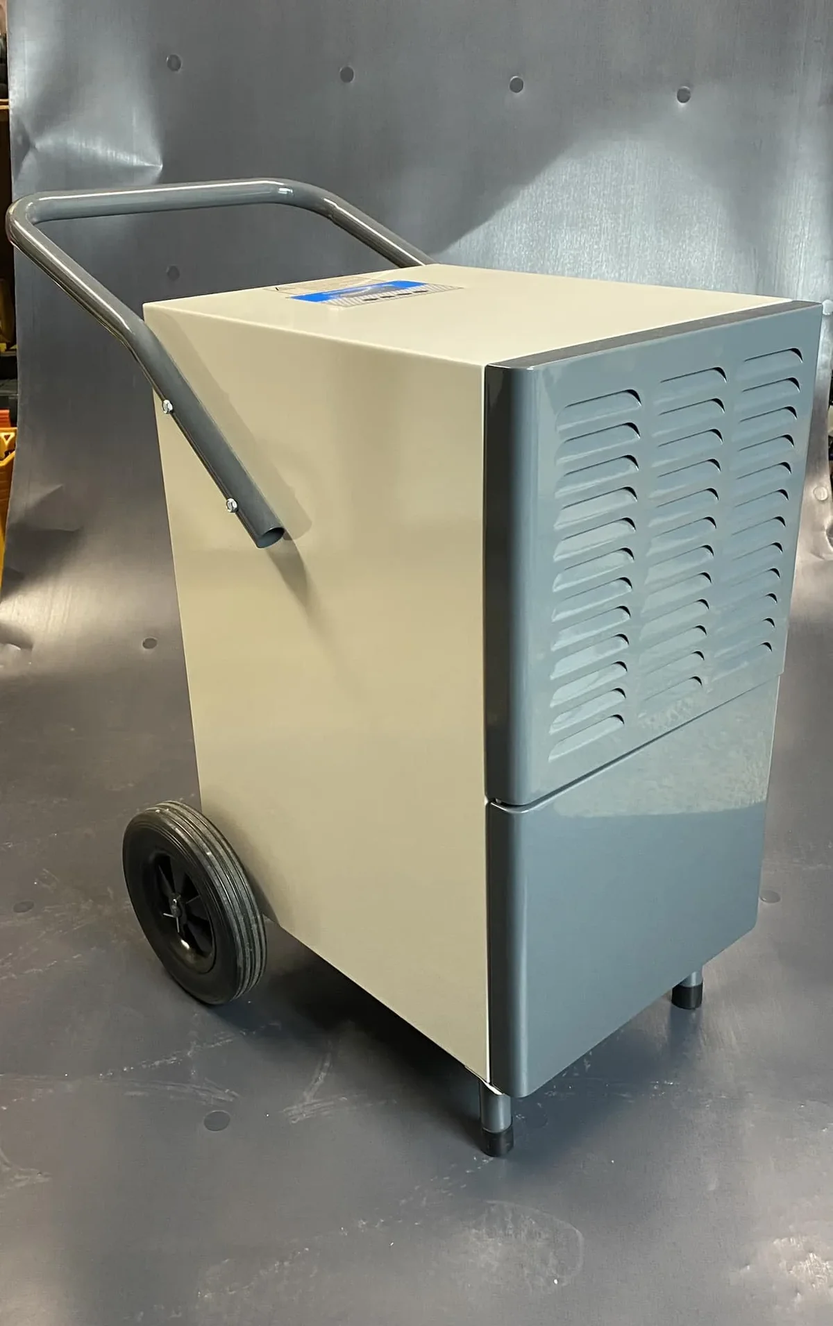 Professional gray dehumidifier on a wheeled cart, available for rent at Co-Dry